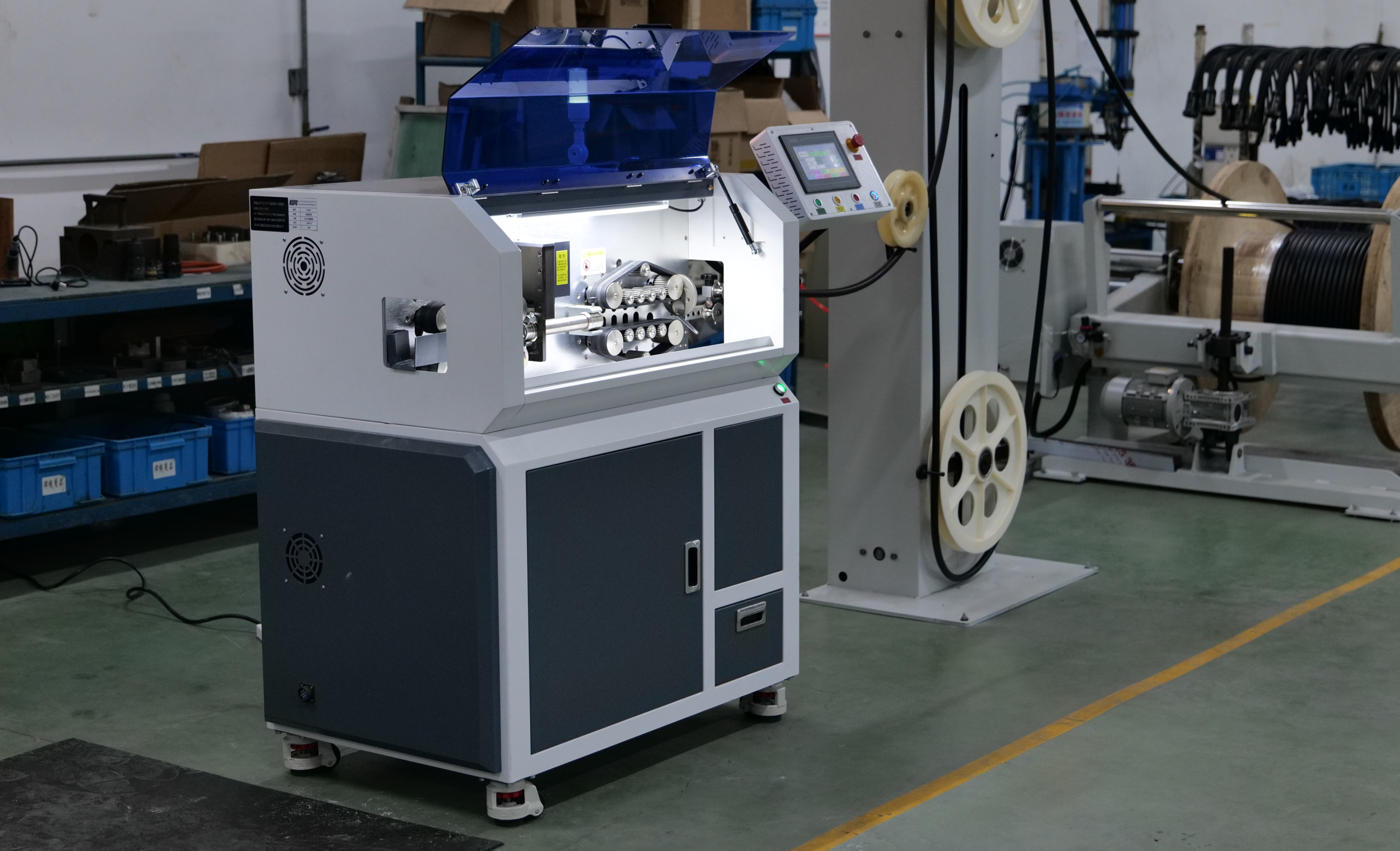 Automated wire processing equipment on KUPO's production floor, used for precision cable assembly manufacturing